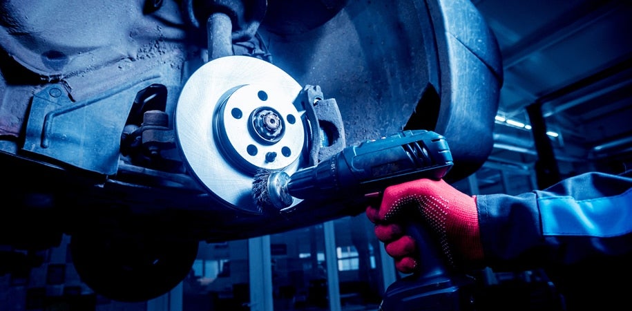 image of a mechanic working on brakes